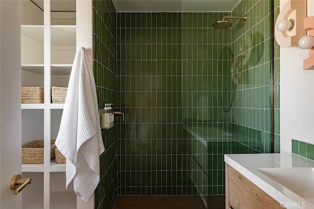 bathroom featuring vanity and a tile shower