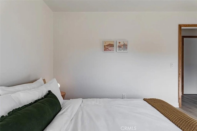 bedroom featuring wood finished floors