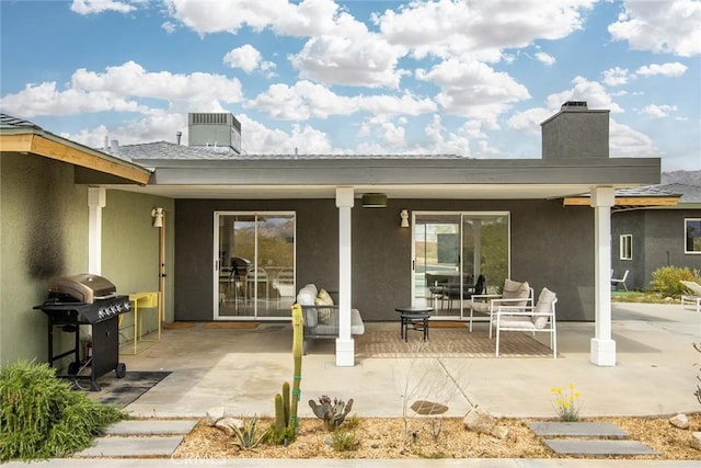 61584 Pueblo Trl, Joshua Tree, CA 92252 - rear view of property featuring a chimney, a patio, and stucco siding