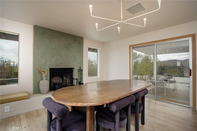 61584 Pueblo Trl, Joshua Tree, CA 92252 - dining area featuring light wood-style flooring and a fireplace
