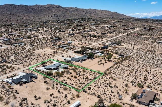 61584 Pueblo Trl, Joshua Tree, CA 92252 - aerial view of sparsely populated area with a desert landscape, a mountain backdrop, and property boundaries highlighted