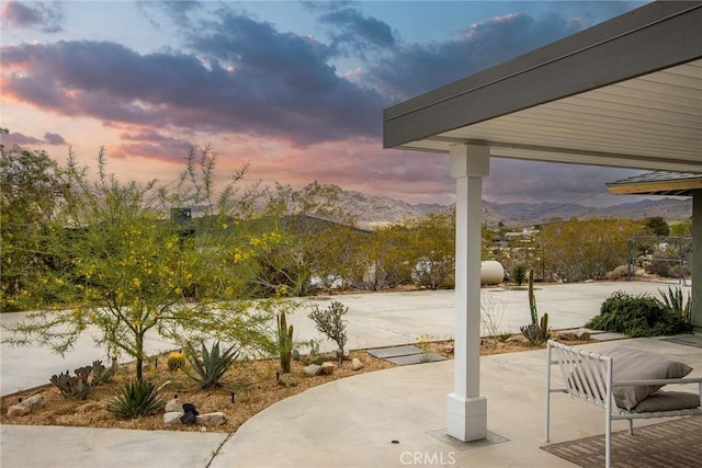 61584 Pueblo Trl, Joshua Tree, CA 92252 - patio terrace at dusk featuring a patio area and a mountain view