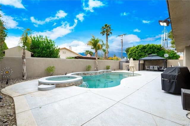 68245 Peladora Rd, Cathedral City, CA 92234 - view of pool with a gazebo, a pool with connected hot tub, grilling area, a fenced backyard, and a patio area