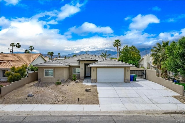 68245 Peladora Rd, Cathedral City, CA 92234 - ranch-style home featuring a garage, fence, stucco siding, a mountain view, and driveway