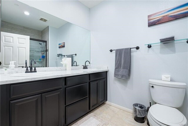 68245 Peladora Rd, Cathedral City, CA 92234 - bathroom with a sink, double vanity, toilet, baseboards, and a stall shower