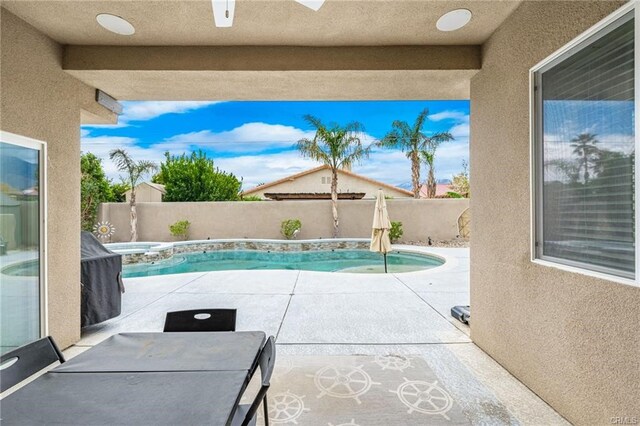 68245 Peladora Rd, Cathedral City, CA 92234 - view of swimming pool with a patio, a pool with connected hot tub, and a fenced backyard