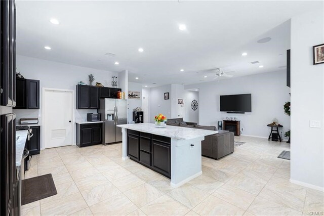 68245 Peladora Rd, Cathedral City, CA 92234 - kitchen with a ceiling fan, a kitchen island, stainless steel refrigerator with ice dispenser, open floor plan, and recessed lighting