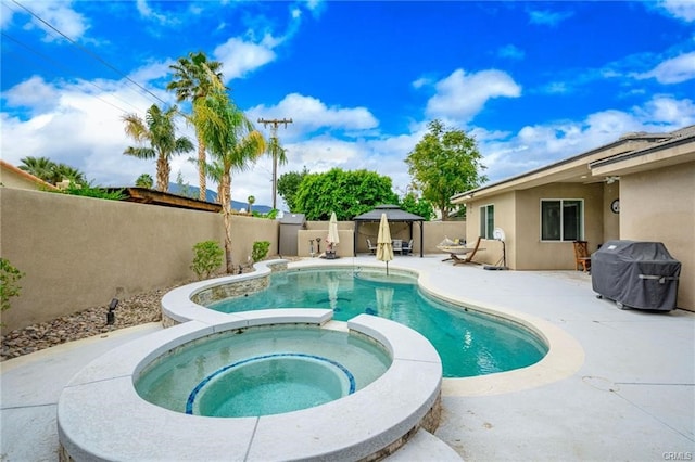 68245 Peladora Rd, Cathedral City, CA 92234 - view of pool featuring a fenced backyard, a patio area, a pool with connected hot tub, and area for grilling