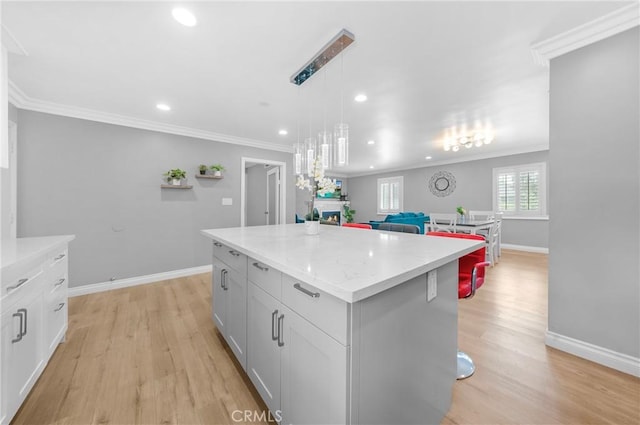 kitchen featuring recessed lighting, baseboards, light wood-type flooring, and a center island