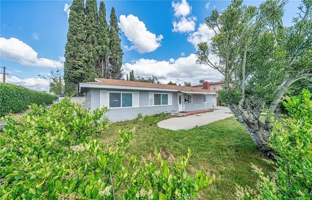 back of property featuring a lawn and stucco siding