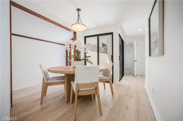dining room with light wood-type flooring, recessed lighting, and baseboards