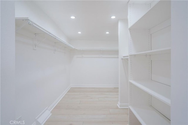 spacious closet featuring light wood-type flooring