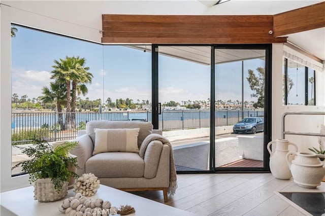 sunroom / solarium with a water view