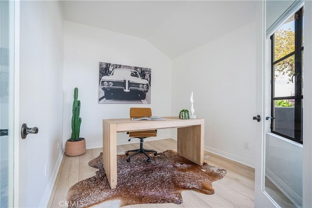 office space featuring baseboards, wood finished floors, and lofted ceiling