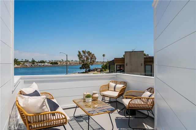 balcony featuring a water view