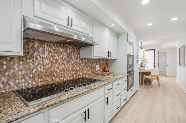 kitchen with white cabinets, under cabinet range hood, black electric stovetop, and oven