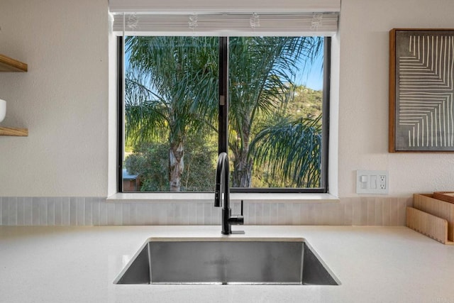 interior details with a sink and light countertops