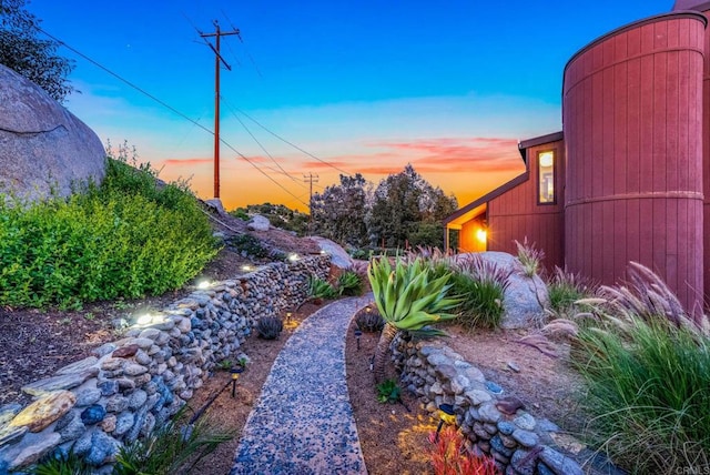 yard at dusk with a barn and an outdoor structure