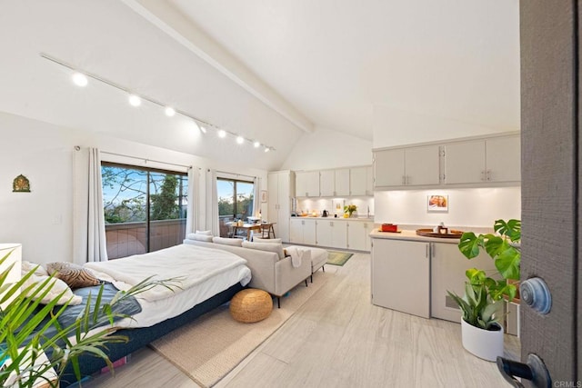 bedroom featuring beamed ceiling, access to outside, high vaulted ceiling, and track lighting