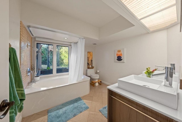 bathroom with vanity, curtained shower, toilet, a bathtub, and tile patterned floors