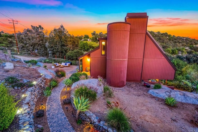 yard at dusk with a barn and an outbuilding