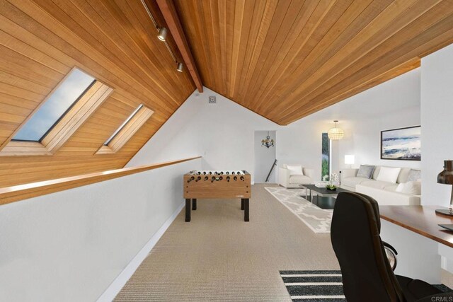 interior space with rail lighting, carpet, baseboards, wooden ceiling, and lofted ceiling with skylight