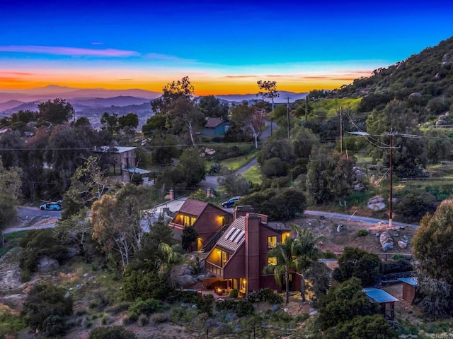 aerial view at dusk featuring a mountain view