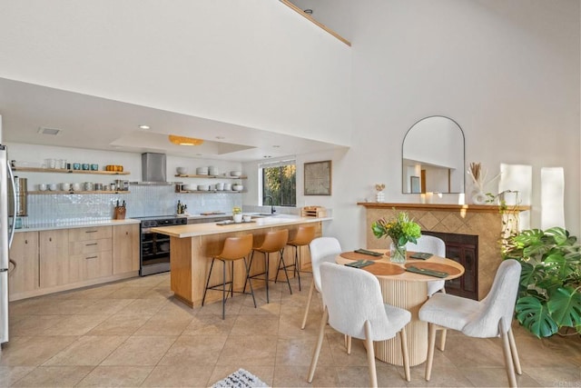 30593 Miller Rd, Valley Center, CA 92082 - dining space with a fireplace, a high ceiling, and light tile patterned floors