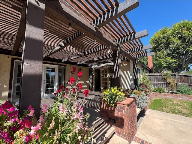 view of patio / terrace with a pergola and fence