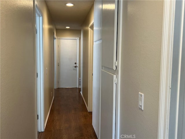 hall with recessed lighting, baseboards, dark wood finished floors, and visible vents
