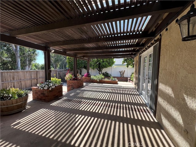 view of patio featuring a fenced backyard, a pergola, and french doors
