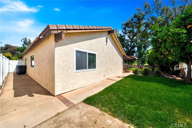31341 Via Sonora, San Juan Capistrano, CA 92675 - view of side of property with a lawn, a fenced backyard, and stucco siding