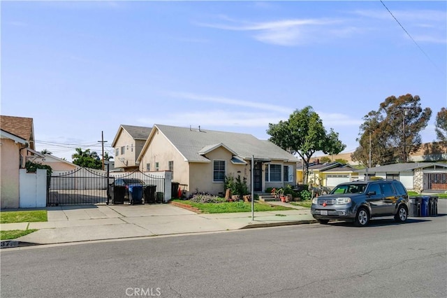 view of front of home with a gate and stucco siding