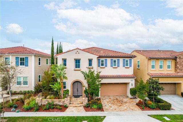 12 Starflower, Lake Forest, CA 92630 - mediterranean / spanish house featuring a garage, driveway, stucco siding, and a tile roof