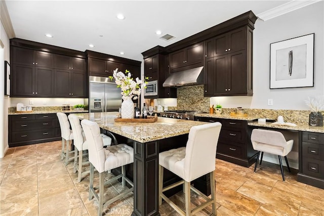 12 Starflower, Lake Forest, CA 92630 - kitchen with built in appliances, ventilation hood, crown molding, a kitchen bar, and backsplash