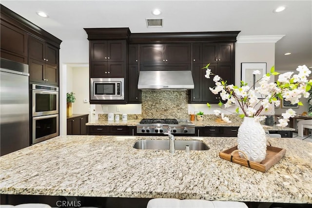 12 Starflower, Lake Forest, CA 92630 - kitchen with ventilation hood, stainless steel appliances, tasteful backsplash, light stone counters, and ornamental molding