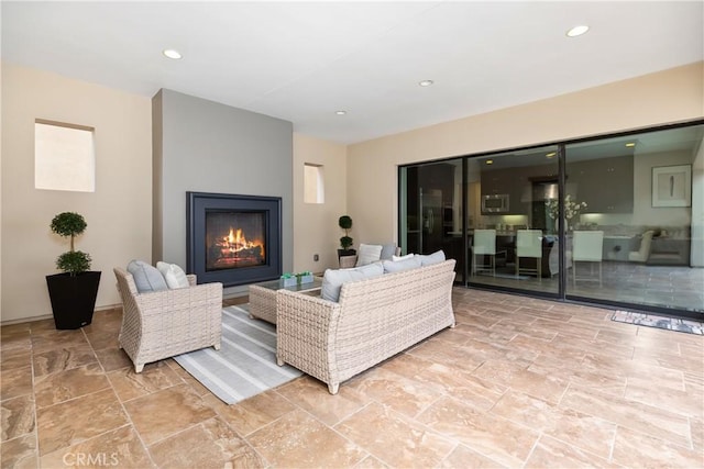 12 Starflower, Lake Forest, CA 92630 - living area featuring a lit fireplace, recessed lighting, and stone finish flooring