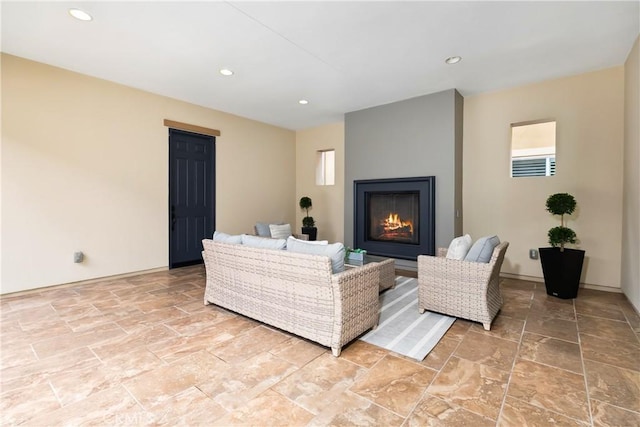 12 Starflower, Lake Forest, CA 92630 - living area with a lit fireplace, light stone finish flooring, recessed lighting, and plenty of natural light
