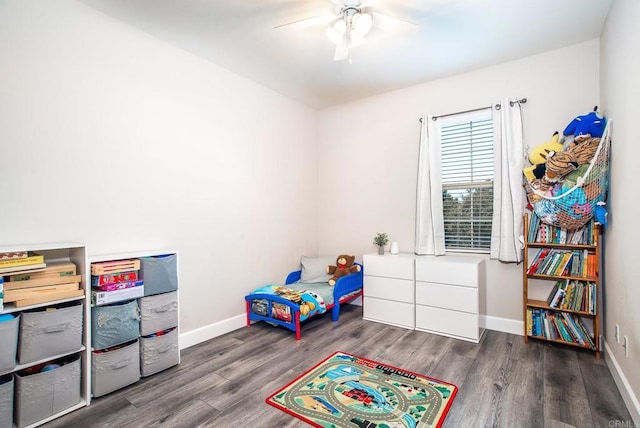 recreation room with baseboards, a ceiling fan, and wood finished floors