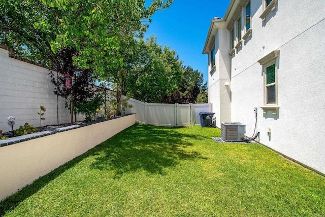 view of yard with a fenced backyard and cooling unit