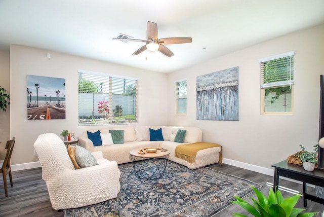 living room featuring baseboards, ceiling fan, dark wood finished floors, and visible vents