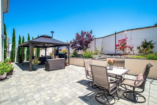 view of patio / terrace with a gazebo, a fenced backyard, and outdoor lounge area