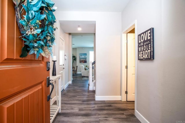 hall with baseboards and dark wood-style floors