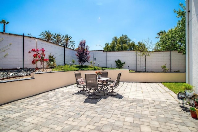 view of patio featuring outdoor dining area and a fenced backyard