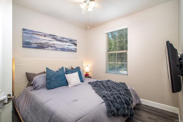 bedroom with baseboards, a ceiling fan, and wood finished floors