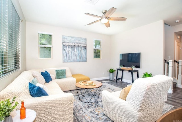 living room with baseboards, a ceiling fan, and wood finished floors