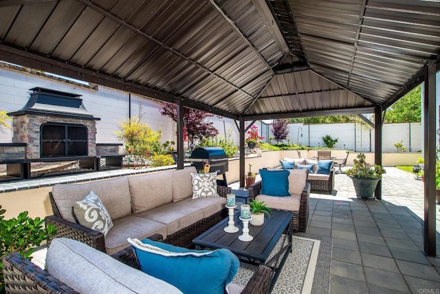 view of patio with a gazebo, outdoor lounge area, fence, and a grill