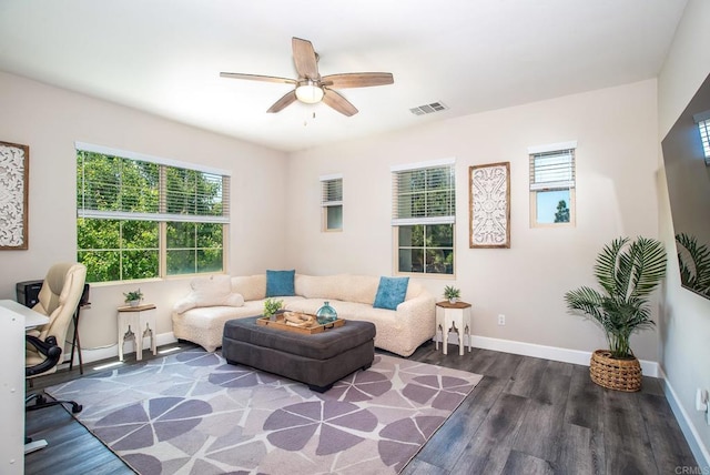 living area featuring visible vents, a ceiling fan, baseboards, and wood finished floors