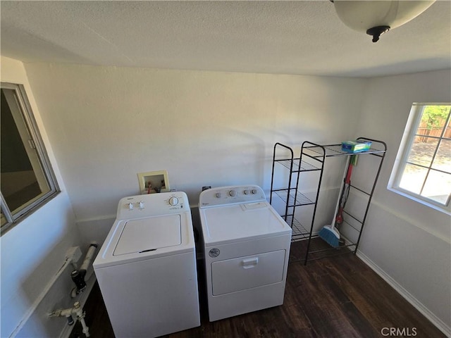 washroom with laundry area, a textured ceiling, baseboards, dark wood-type flooring, and washing machine and dryer