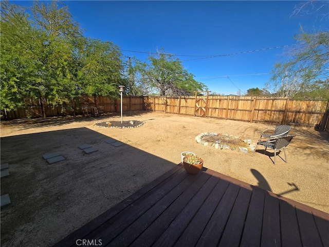 wooden terrace with a fenced backyard